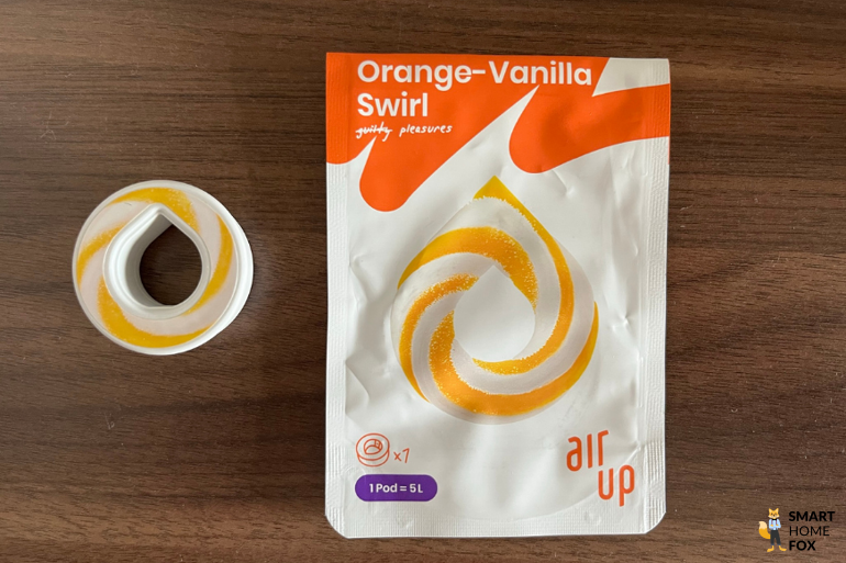 Ein Bild, welches den Pod und die Verpackung des Geschmacks Orange-Vanilla-Swirl zeigt.