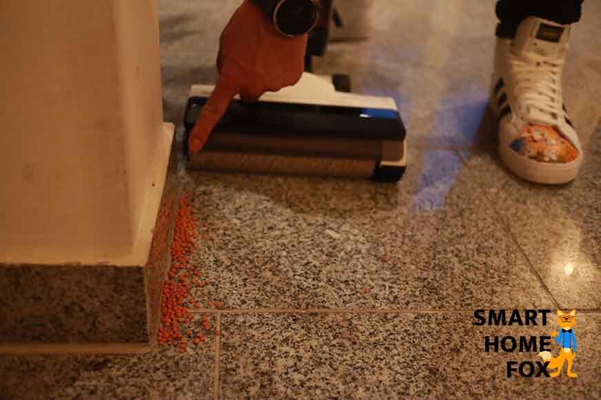 Man sieht, wie an einer Kante mit einem Akku-Saugwischer geputzt wird.