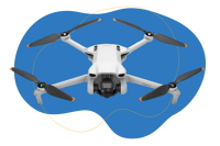 Die DJI Mini 3 Pro Drohne steht vor einem blauen Hintergrund.