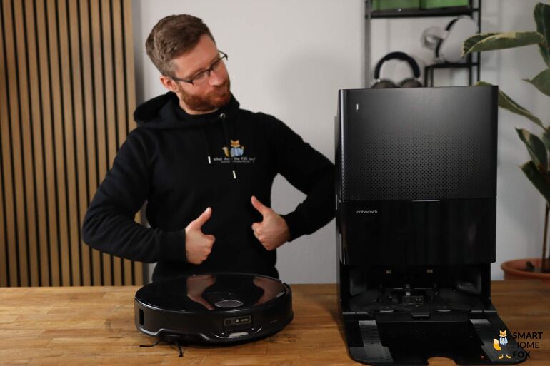 Die Dockingstation des Roborock Qrevo Slim steht auf dem Tisch und wird von einem Smart Home Fox Mitarbeiter begutachtet.