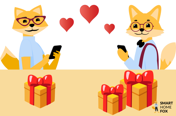 Smart Home Fuchs und Füchsin mit Handy neben herzen und Geschenken