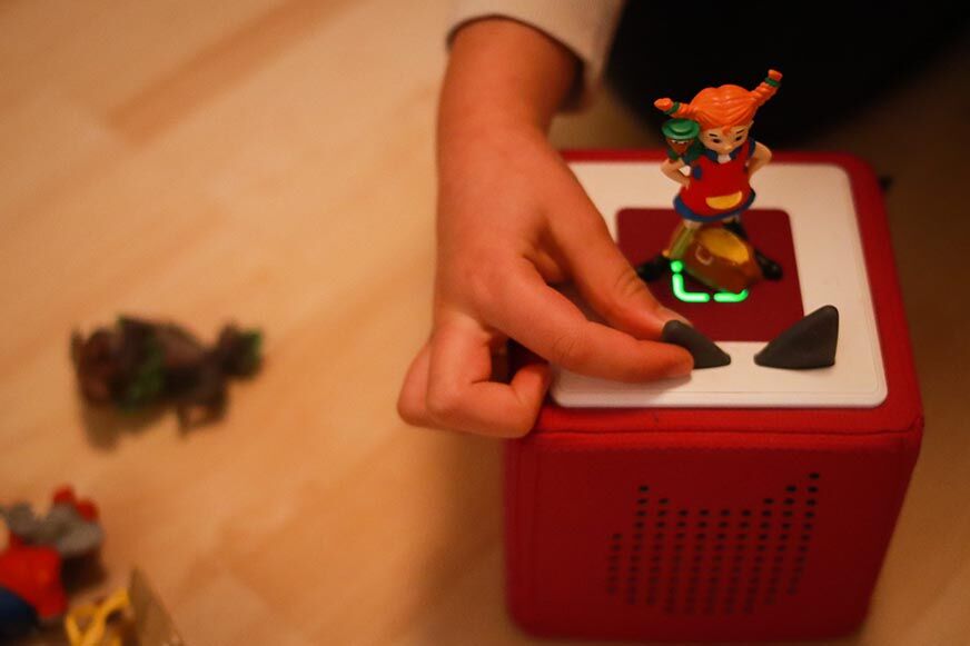 Kind drückt auf Tonieohr