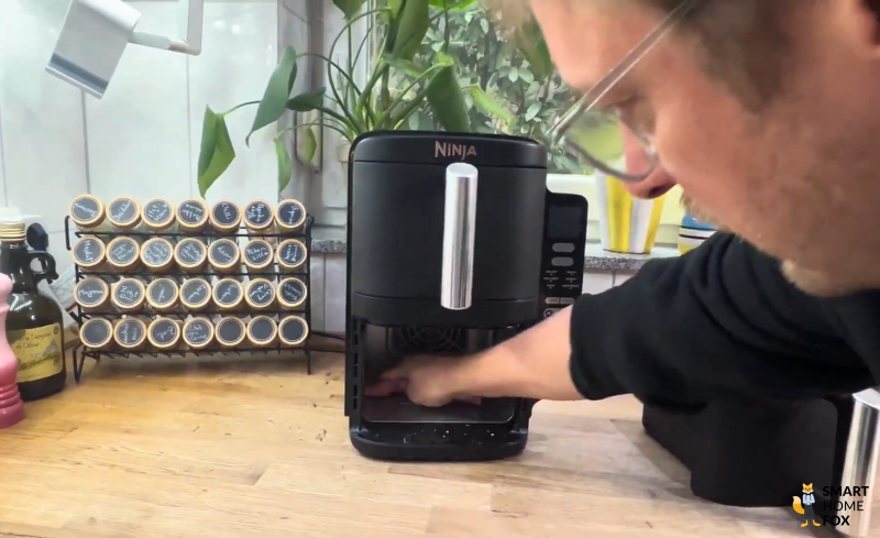 Reinigung der unteren Innenfläche beim Ninja Double Stack: Mit einem einfachen Handgriff lassen sich Krümel und Rückstände entfernen – ideal für die regelmäßige Pflege der Heißluftfritteuse im Alltag.