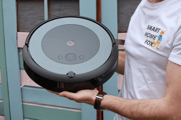 iRobot Roomba i3 wird beim Test hochgehalten